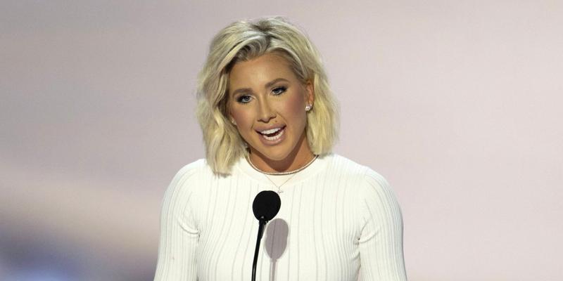 Savannah Chrisley speaking in front of a crowd of people at the RNC.