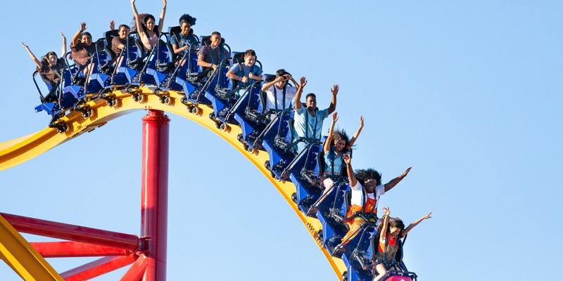 Guests riding a roller coaster