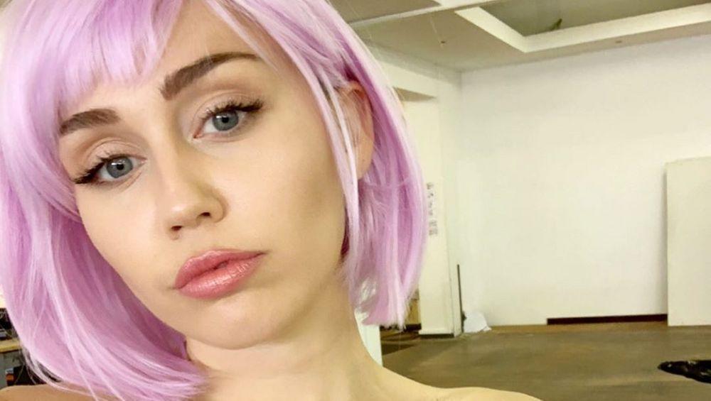 Miley Cyrus Opens WIDE With Shoulders Bare While Smashing Records